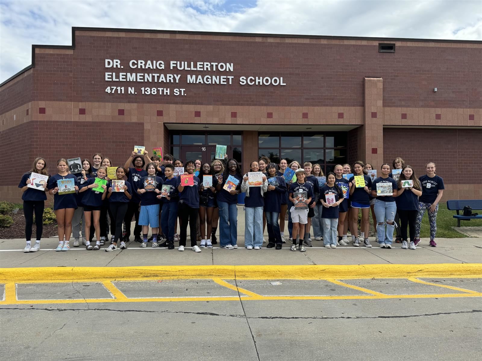  njhs students holding books in front of fullerton elementary